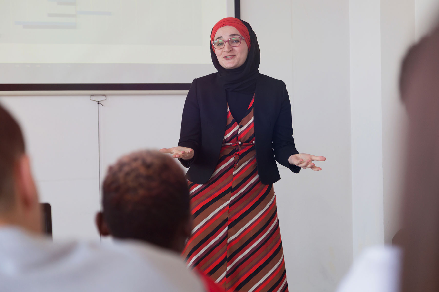 Female teacher/professor teaching in the front of the class