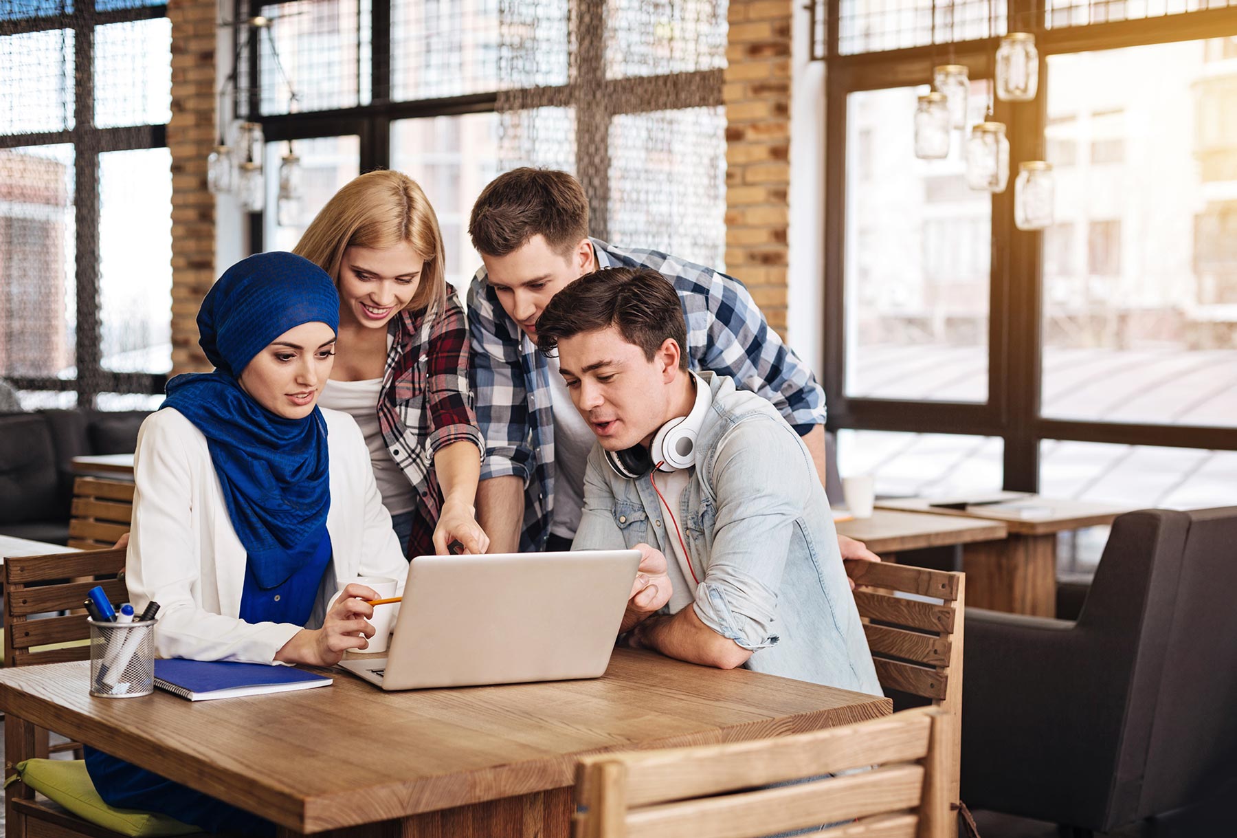A group of students working together on a laptop
