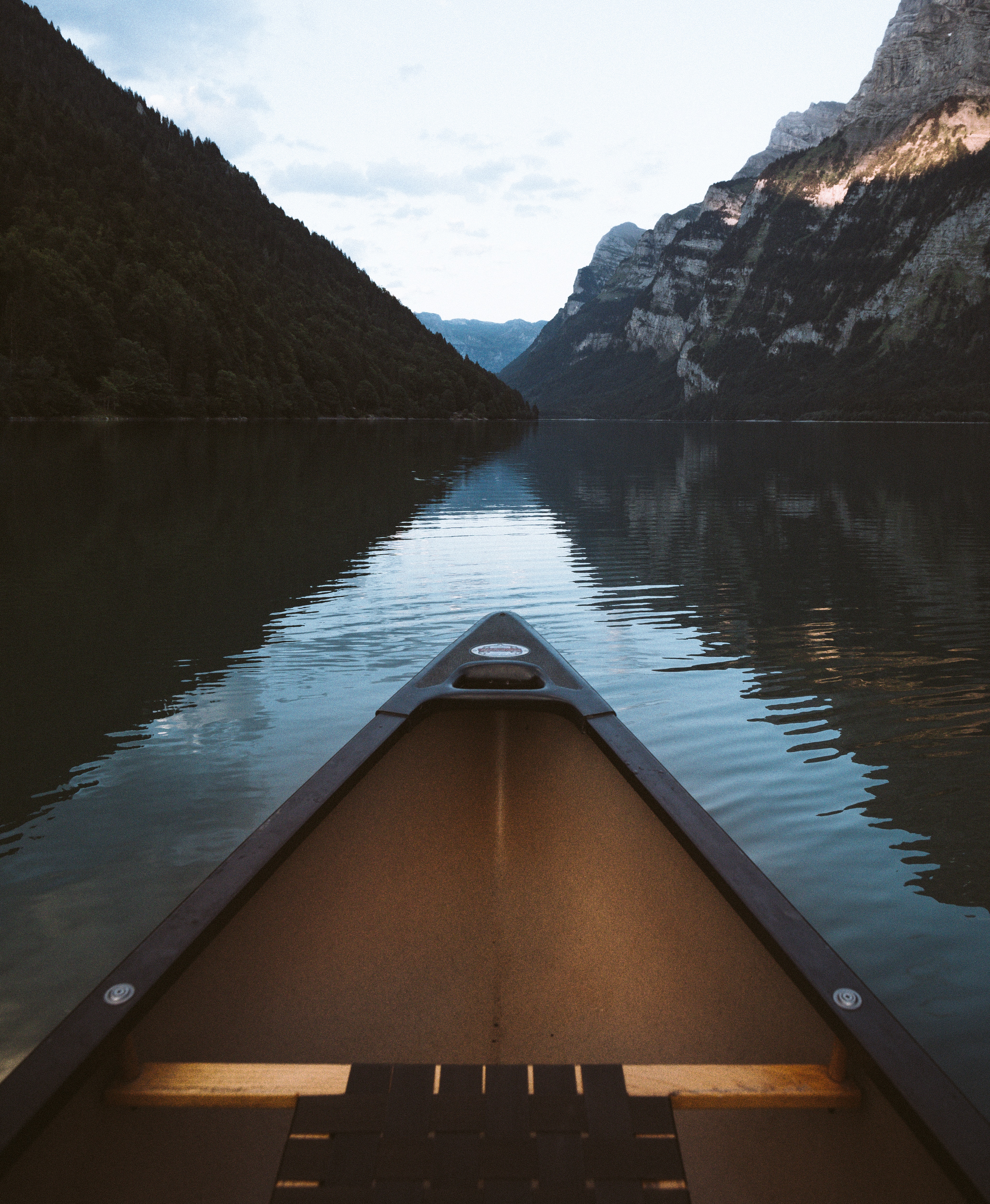 View of a small boat on a lake surrounded by mountains.