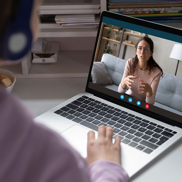 Two people having an online conversation using a laptop.