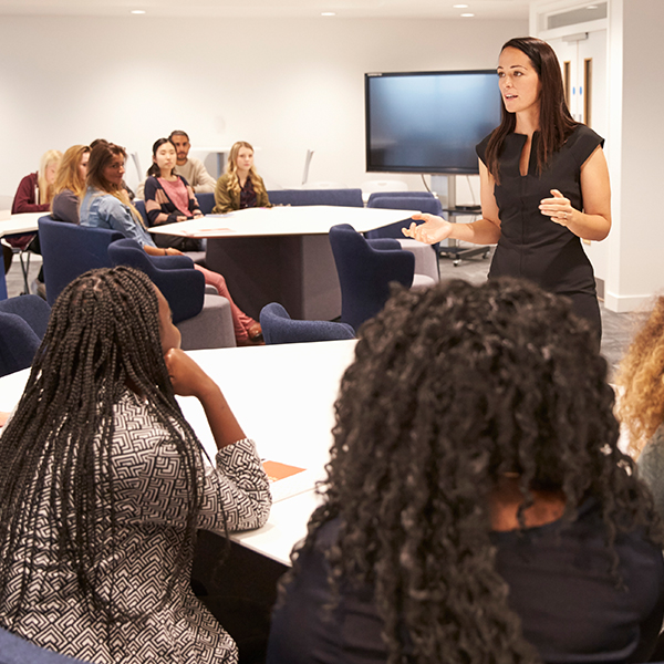 An instructor engaging students in a classroom setting.