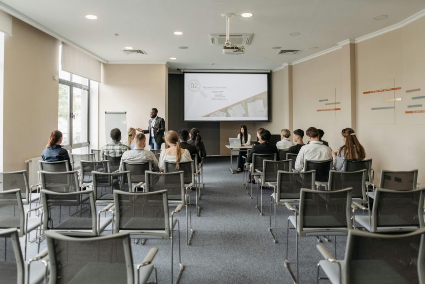 A group of people sitting in a conference room